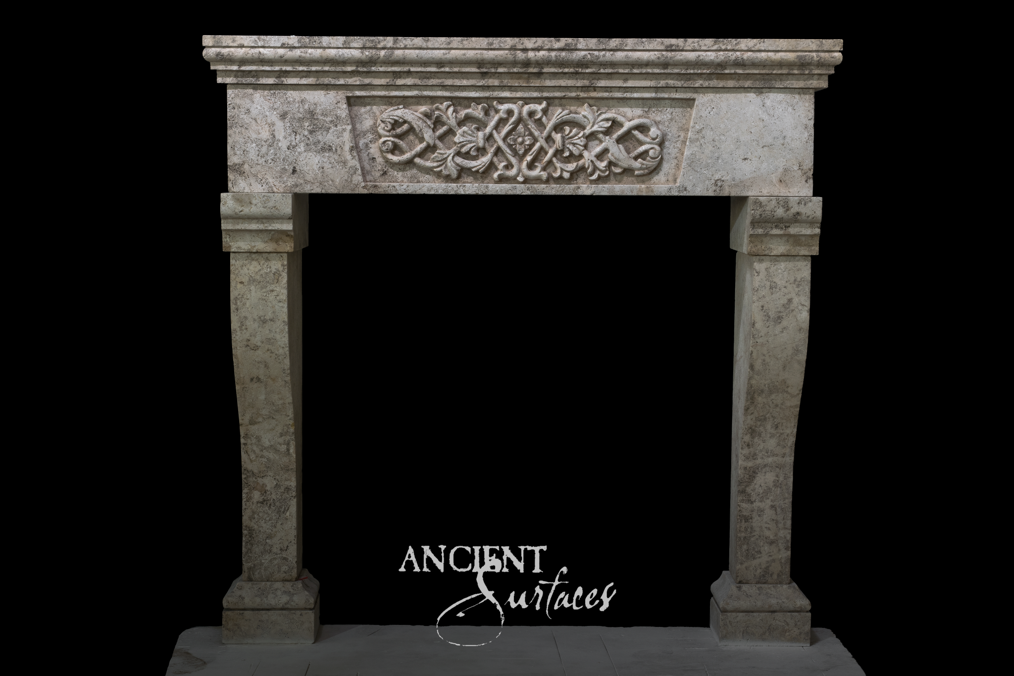 Mottled grey limestone fireplace mantel with a carved interlace strapwork panel on the frieze and gently flared jambs