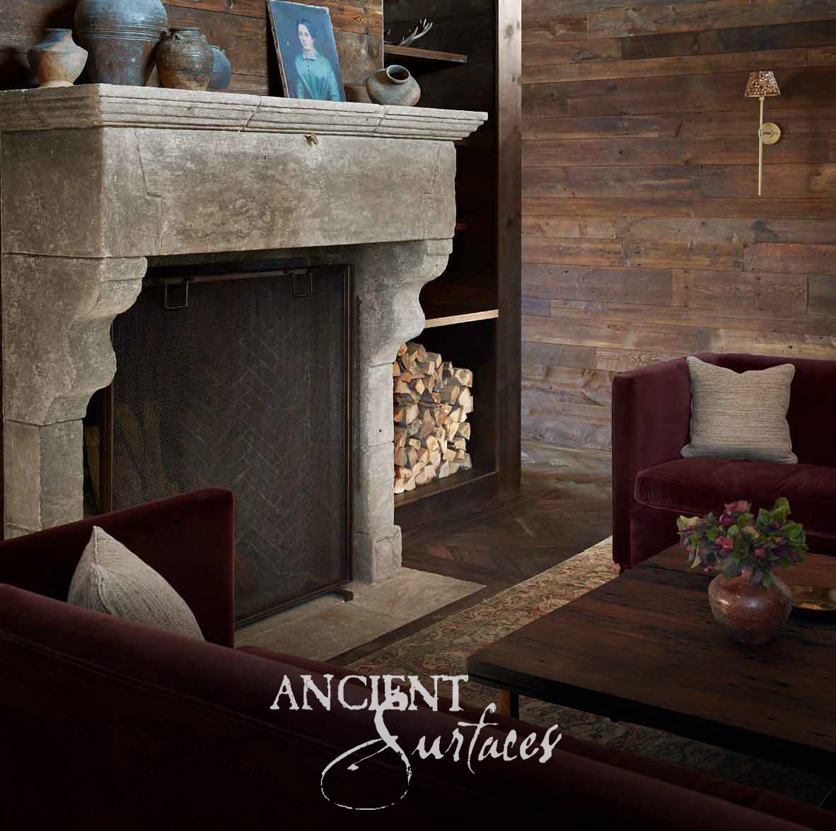Deeply weathered grey limestone fireplace mantel with a heavy molded cornice, tall plain hood and shaped corbel brackets