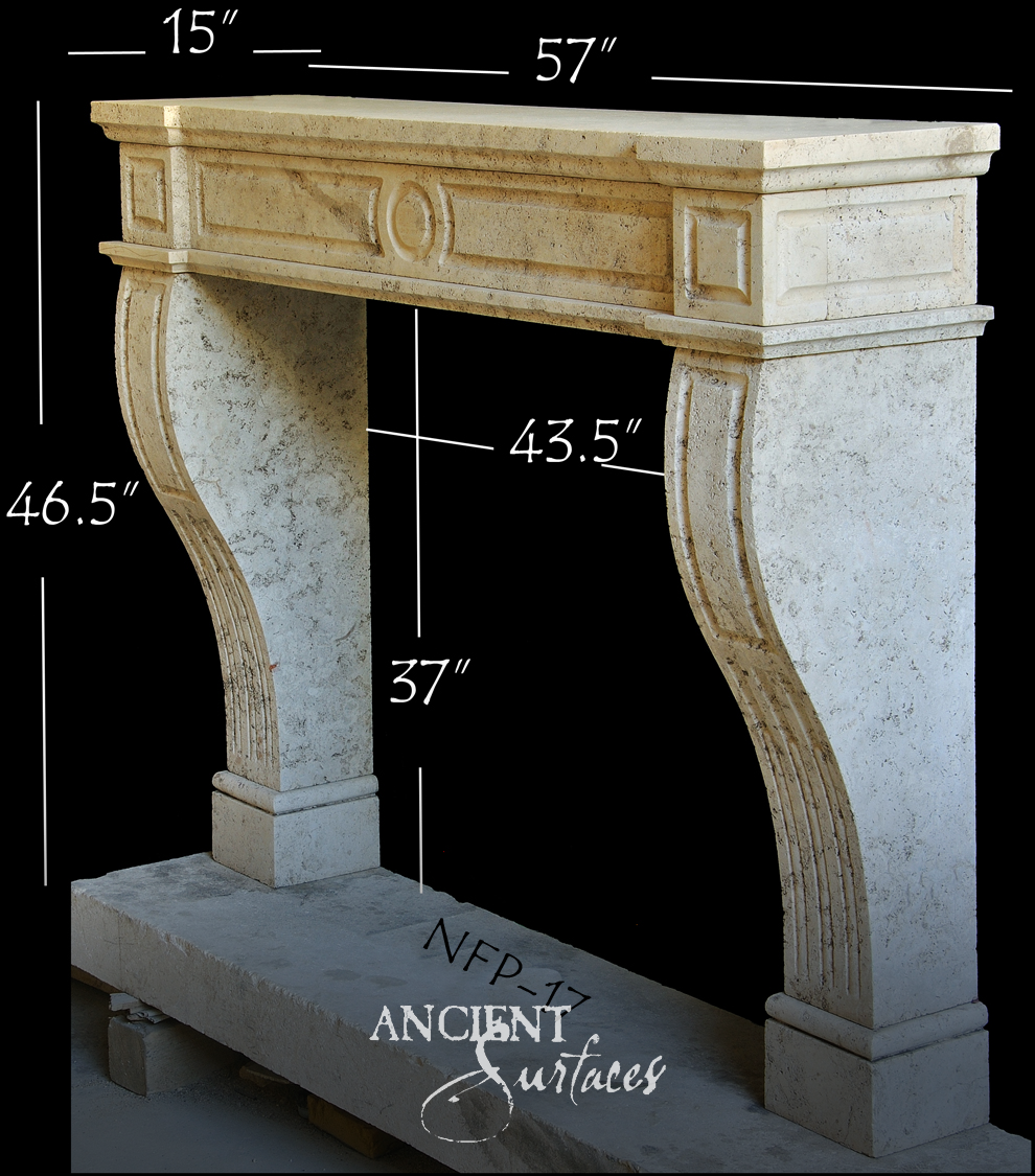 Honey toned limestone fireplace mantel with a paneled frieze, carved oval roundel and curved legs reeded along their full length